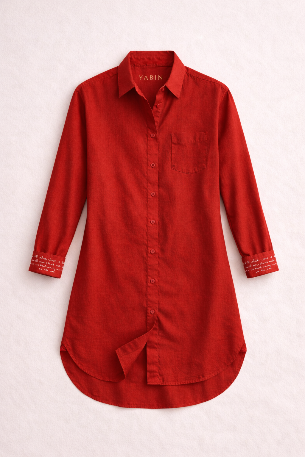 Red Peace shirt dress with flipped cuff sleeve on a light beige background